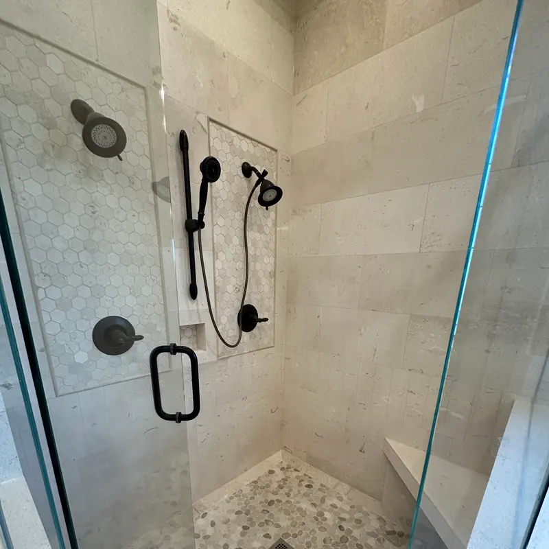 Marble shower with pebble pan and hex niche, Atlanta GA